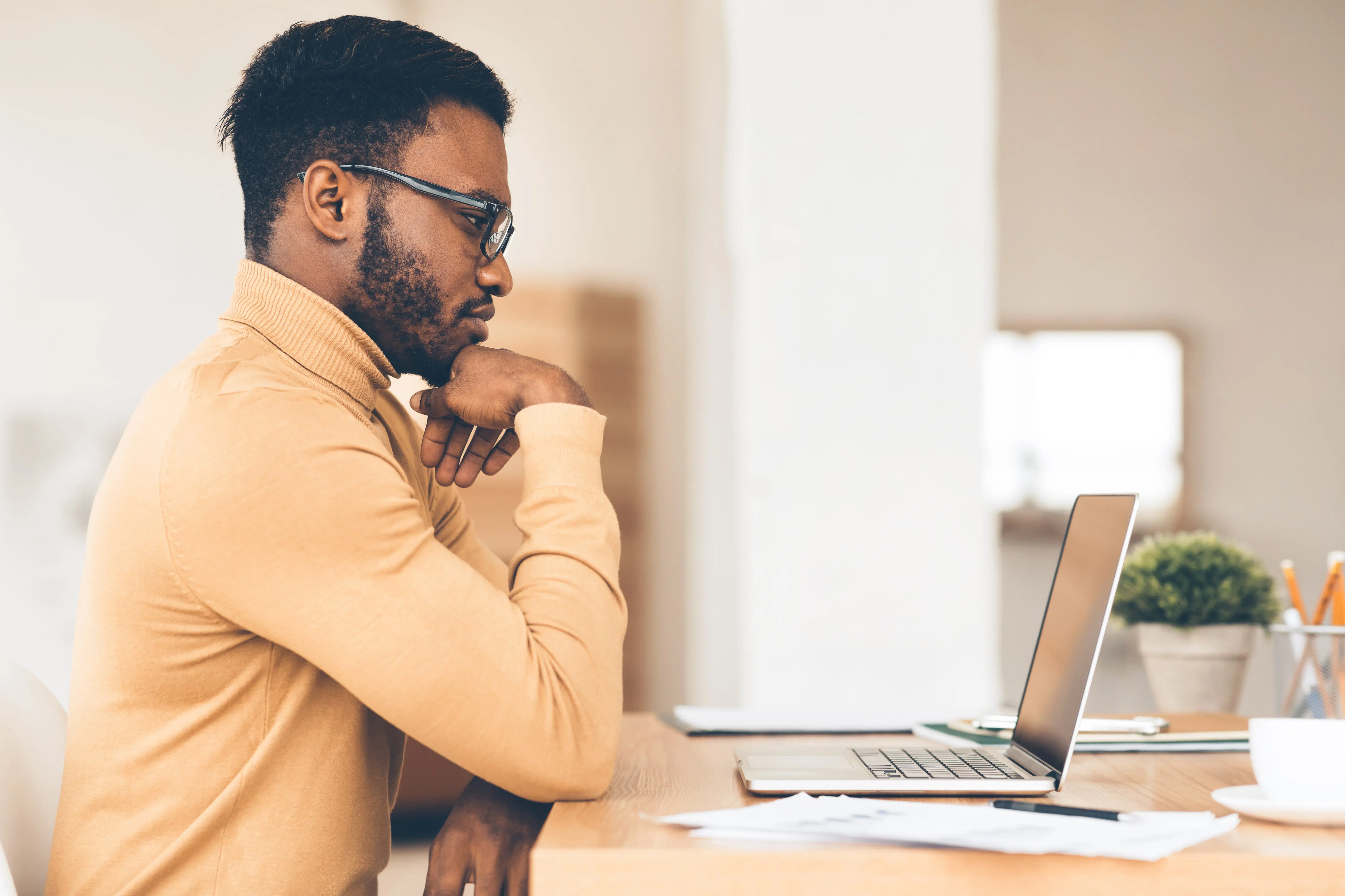 black-guy-working-on-his-laptop-at-home-compress SEO Consultant